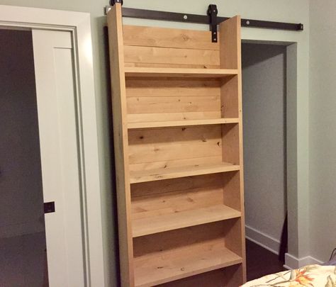 Our rad new sliding closet bookshelf barndoor -- Thanks Tommie Silva! Sliding Storage Door, Secret Bookcase Sliding Door, Sliding Door Shelves, Sliding Door With Storage, Diy Door Bookcase, Sliding Storage Doors, Bathroom Storage Sliding Door, Sliding Book Shelves, Sliding Door With Shelves