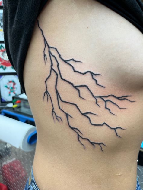 Lightning Bolt Rib Tattoo, Tattoo Ideas Female Lightning, Lightning Side Tattoo, Lightning Bolt Tattoo Rib Cage, Lightning Bolt Tattoo Stomach, Lighting Tattoo Design Women, Lightning Bolt Tattoo Women, Thunderstorm Tattoo Women, Ride The Lightning Tattoo