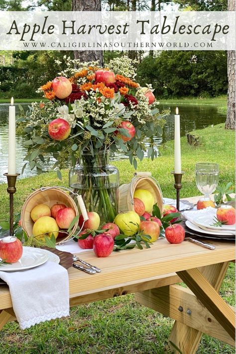 Apple harvest tablescape with a floral arrangement, apple votive candle holders and lots of apples. Apple Bridal Shower Ideas, Apple Table Decorations, Harvest Tablescape, Apple Theme Parties, Fall Festival Party, Apple Centerpieces, Apple Table, Apple Orchard Wedding, Fall Tea