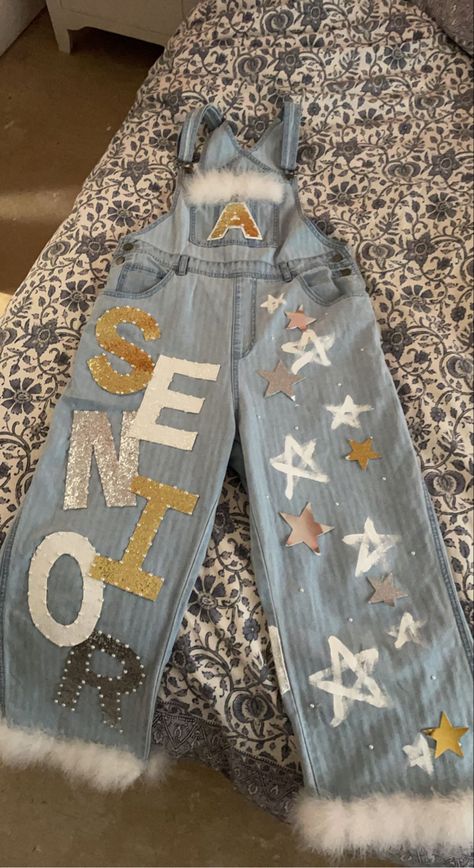 senior homecoming overalls gold and silver lightwash denim pearls feathers Overalls Senior Homecoming, Texas Homecoming Overalls, Hoco Overalls Freshman, Painted Hoco Overalls, Senior Overalls Ideas 2024, White Homecoming Overalls, Overall Decorated Ideas, Senior Jeans Black And Gold, Senior Jeans Overalls