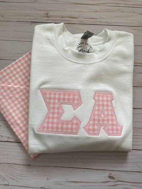 Good Golly Greek Pink Gingham Sorority Stitched Letters. Looking for the perfect gift for the sorority sister in your life? Look no further! These letters are the perfect way to rep a sorority on and off campus. To order a pair for your chapter, click the link to our website. #Preppy#SororityApparel#StitchedLetters#SigmaAlpha#BigLittleBasket#InitiationBasket#Embroidered#Coquette#Girly Pink Sorority Letters Sweatshirt, Stitched Letters Sorority, Stitch Letters Sorority, Sorority Stitched Letters, Sorority Letters Sweatshirt, Greek Letters Painted, Big/little Baskets, Stitched Letters, Stitch Letters