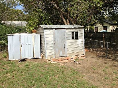 Just in time for Spring! We transformed our super ugly sheds with very little money with scrap pallet, fence, and miscellaneous lumber. The door on the large shed was our old back door (we replaced with a glass door from Habitat ReStore). We also used paint we were given to paint the blue shed. Even the flower box brackets were in someone's trash. Our "splurge" was the fun orange paint for the doors! Visit our site for a few in-between steps: http://upcycledugly.com/yard-make-over/… Shed Redo, Garden 101, Blue Shed, Shed Makeover, Pallet Projects Garden, Habitat Restore, Dream Bedroom Inspiration, Coffee Shop Photography, Pallet Fence