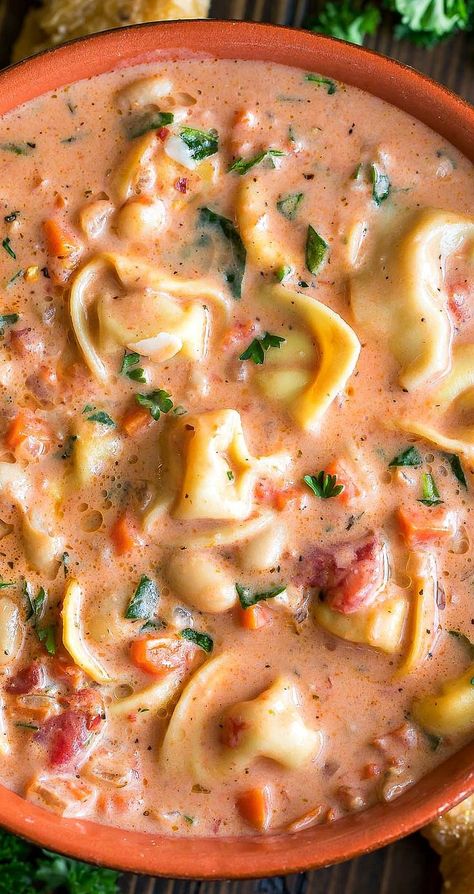 This creamy Tuscan Tortellini Soup is crazy delicious and can made quickly in just one pot! Aren't one-pot recipes the best?! Each luscious bowl is loaded with cheesy tortellini, fresh veggies, and tender white beans for a filling and flavorful soup!  This vegetarian recipe is easy to make and totally crave-worthy! Sopa Toscana, Creamy Tuscan Tortellini, Tortellini Soup With Spinach, Tuscan Tortellini Soup, Tuscan Tortellini, Soup With Spinach, Creamy Tortellini Soup, Pesto Tortellini, Pasta Salad With Tortellini