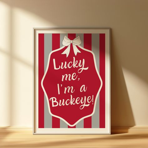 Lucky Me wall art | THE Ohio State University decor | Red and white striped print | Preppy college dorm decor | Ohio State football fan art | Game day aesthetic | Bow-themed wall art | Ohio State apartment decor | Buckeye room inspiration | Ohio State bar cart art | Trendy University of Alabama wall print | Buckeyes preppy style | Ohio State aesthetic home decor | Football-themed wall decor | Preppy Buckeye decor | Ohio State gameday room ideas | College apartment style Ohio State Aesthetic, Grey Dorm Room, Game Day Aesthetic, Preppy College Dorm, Wall Decor Preppy, Aesthetic Bow, Preppy College, Trendy Bows, Bar Cart Art