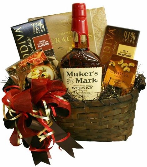 Makers Mark Bourbon Whiskey Gift Basket  The Maker's Mark Bourbon Whisky Gift Basket includes a 750 ml btl of Maker's Mark which is rich with a buttery nose and hints of raisins and honey; flavors include vanilla, honey, oranges, and a well balanced backdrop of leather and spice. Packaged in a dark willow basket and includes: peppercorn brie spread crackers Godiva chocolate covered cashews Godiva Milk chocolate bar & Dark Chocolate bar Price: $85.00 #bourbon #gift #giftbasket #holiday Bourbon Gifts Basket, Whiskey Gifts Basket, Liquor Gift Baskets, Thanksgiving Gift Basket, Caramel Pecans, Flavored Liquor, Auction Basket, Liquor Gifts, Raffle Basket