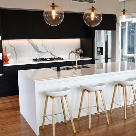 This stunning new kitchen renovation was completed using Laminex Absolute Matt Black cabinets, with White Cabinets to the Island Bench complimented by Quantum Quartz Alpine White Stone Benchtops and Statuario Six Splashback. Quantum Quartz, Island Cabinets, White Island, Island Bench, New Kitchen Designs, Alpine White, Black Cabinets, White Kitchen Cabinets, White Cabinets