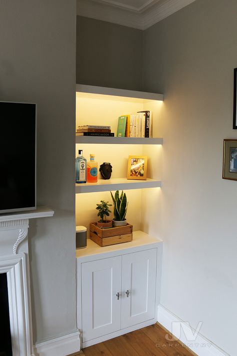 Illuminate your cherished collections with floating shelves that do more than just hold your items—they light them up! Our blog post guides you through 14 chic designs of floating shelves with integrated lighting, perfect for showcasing and adding a warm ambiance to any room. Add a modern touch to your space while keeping it tidy and bright. #GoTinySpace #FloatingShelvesWithLights #ModernHomeDecor Wall Inset Shelves, Shelf In Alcove, Shelving Alcove Ideas, Alcove Lighting Living Room, Living Room Fireplace Shelves, Small Built In Shelves Living Room, Narrow Alcove Ideas, Shelves In Alcoves, Modern Alcove Ideas