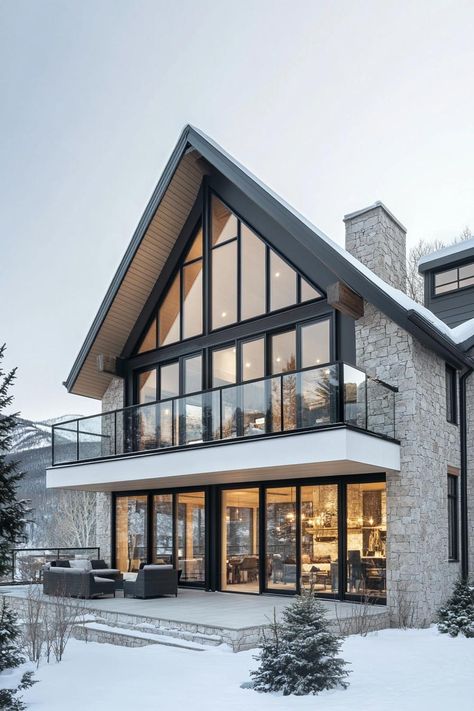 Modern A-frame stone house in snowy setting. From rustic mountain retreats to urban lofts with views worth a million bucks (or maybe we’re just out of breath from the altitude), Colorado homes have their very own kind of charm. Modern Mountain Home Walk Out Basement, Alpine House Design, Contemporary Mountain Home Exterior, Rustic Modern Cabin Interior, Mountain Villa Design, Mountain Side Homes, Mountain Modern Home Interiors, Mountain Homes Interiors, Modern Mountain Home Exterior