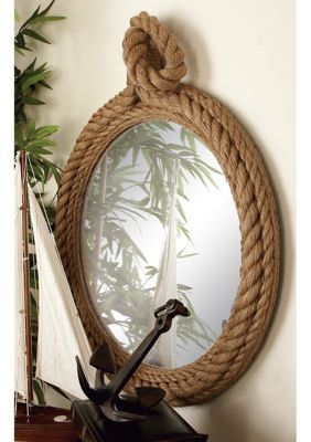 A coastal inspired space is built around the idea of a laid-back, carefree vibe This decorative wall mirror is made from a combination of hemp rope and glass This coastal wall mirror has a light brown frame for a natural touch This round wall mirror features a textured rope frame and a large, reflective surface in the center This item measures 23”L x 2”W x 34”H; weighs 8 lbs | Monroe Lane 24 in x 35 in Round Brown Wooden Wall Mirror with Hemp Rope Nautical Mirror, Rope Wall, Rope Mirror, Beachfront Decor, Rope Frame, Wall Mirrors Set, Entryway Mirror, Nautical Bathrooms, Wood Wall Mirror