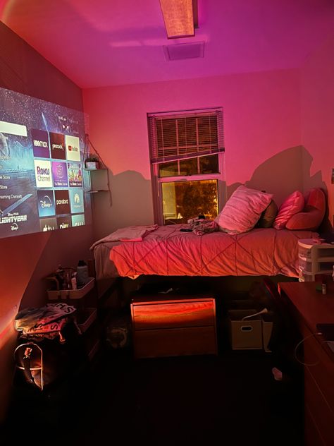 dorm room decor, a projector with LED lights! comfy bed and good space Projector Dorm Room, Led Light Dorm Room, Cozy College Dorm Aesthetic, Projector In Dorm Room, Dorm Room Projector, Dorm Room At Night, College Dorm Led Lights, Led Dorm Room Ideas, Dorm Room Ideas 2024