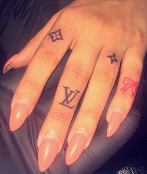 Louis Vuitton Hand Tattoos, Hand Tattoos Idea, Money Bag Finger Tattoo, Small Women Hand Tattoos, Lv Hand Tattoo, Cheetah Print Hand Tattoo, Juicy Couture Tattoo, Name Hand Tattoos For Women, Girlie Tattoo Ideas