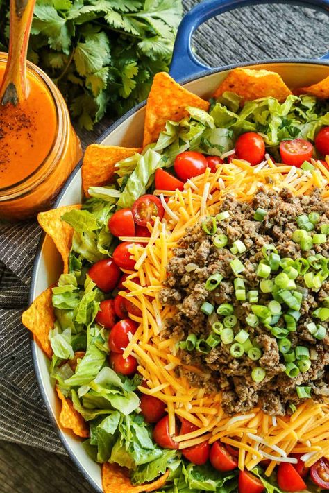 This Dorito Taco Salad with Creamy Taco Dressing is bursting with fresh veggies, plus seasoned beef and crunchy, nacho cheese-y, irresistible Doritos! #doritos #tacosalad #salad Taco Dressing Recipe, Taco Dressing, Desserts To Go, Easy Taco Salad Recipe, Taco Salad Dressing, Pizza Ranch, Grilled Romaine Salad, Taco Salad Recipe, Southwest Chicken Salad