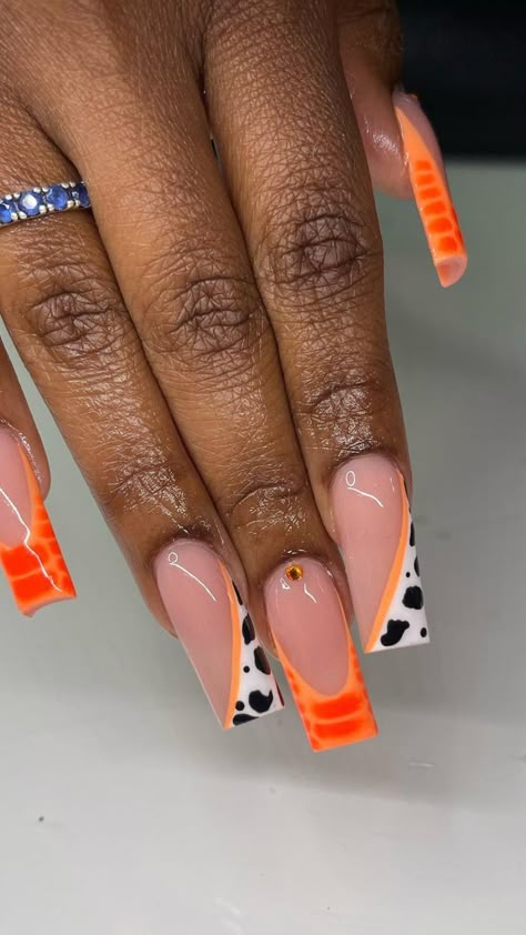 Hand displaying almond-shaped nails with a peach French tip design and an accent nail featuring an orange flower pattern. Orange Nail Ideas, Cute Short Nail Designs, Bright Acrylic Nails, Bright Orange Nails, Bold Nail Art, Short Almond Shaped Nails, Nail Ideas For Summer, Nail Designs For Summer, Orange Nail Designs