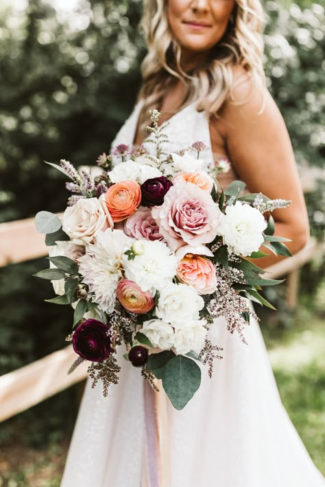 Blush, peach, and burgundy bridal bouquet by Feisty Flowers. Photography by Hello Rose Photography (hellorosephotography.com)  #bridalbouquet #milwaukeeflorist #texturalbouquet #ranunculus #summerwedding #milwaukeewedding Burgundy Peach Pink Wedding Flowers, Bride Bouquets May Wedding, Burgundy Peach Cream Wedding, Bridal Bouquet September Wedding, April Bridal Bouquet, Wedding Flowers Ranunculus, Neutral Bouquet With Pop Of Color, Bridal Bouquet November, November Bridal Bouquet