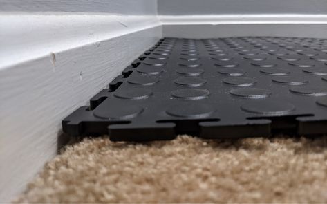 The best way to install tiles on a carpeted floor is to remove the carpet. Ripping up the carpet would at first thought to be the more complicated way to go. Soft carpet is not firm enough and installing tiles over it could cause serious injury especially if the room in question will be used for physical activity such as a gym. Tiles made of rubber will separate from each other even if they are interlocking. Add in the machines and weights of a gym and you have a recipe for disaster. Home Gym Carpet Floor, Gym Carpet Floors, Ikea Gym Mat, Interlocking Foam Floor Tiles, Basement Flooring Waterproof Greatmats, Workout Room Flooring, Temporary Flooring, Foam Floor Tiles, Interlocking Floor Mats