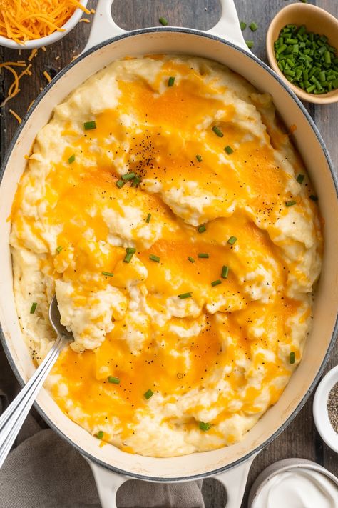 Buttery, fluffy, cheesy mashed potatoes are irresistibly delicious. Made with cream cheese, milk, sour cream, and butter, and topped with melty shredded cheddar cheese, they're the perfect dish to accompany a holiday turkey, a comforting meatloaf, or sweet and smoky grilled ribs. Guaranteed to be a favorite around the dinner table! Grilled Ribs, Cheddar Mashed Potatoes, Cream Cheese Fruit Dip, 40 Aprons, Best Baked Potato, Air Fryer Baked Potato, Easy Skillet Meals, Cheesy Mashed Potatoes, Ranch Dressing Recipe