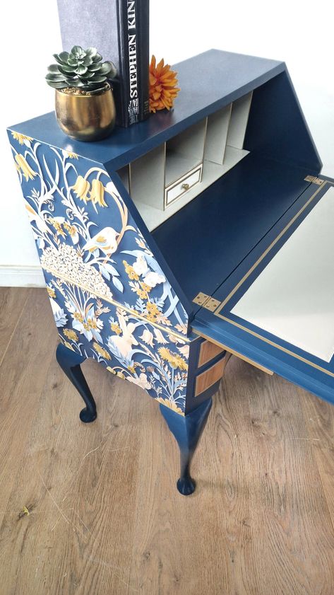 This beautiful walnut bureau has plenty of storage keeping all your paperwork neat and tidy and you very organised. Handpainted in fusion mineral paint willowbank a striking dark navy matched with a gold pigment on added featured throughout the bureau. The beautiful Walnut grain on the drawer fronts and main bureau leaf have been sanded back to reveal its original beautiful grain and has been fully protected with several nourishing varnish topcoats. The bureau consists of 2 drawers fully lined w Painted Writing Bureau, Writing Bureau Upcycled, Desk Painting Ideas Creative, Eclectic Desk, Painted Antique Desk, Secretary Makeover, Antique Desk Makeover, Wallpaper Desk, Painted Desks