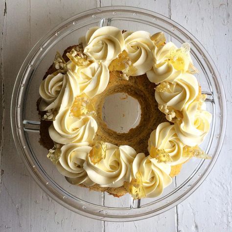 Lemon bundt cake with swiss meringue buttercream roses and mixed nut brittle. Who’s for a slice? • • • #cake #baking #buttercream #piping… Decorated Pound Cake, Pound Cake Decoration, Bundt Cake Decor, Best Lemon Bundt Cake, Bundt Cake Decorating, Decorated Bundt Cakes, Bundt Cake Decorating Ideas, Scottish Farmhouse, Wedding Cocktail Hour Food