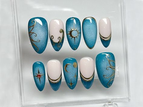 💅🌊 Mystical Ocean Press On Nails Stiletto | Celestial Nautical Nail Art | Custom Press Ons | Fakes For Nails | Design with Sun and Moon Charms 🌊💅 Dive into the mystic with our Mystical Ocean Press On Nails Stiletto - a deep oceanic set that's designed to captivate and enchant. Adorned with celestial nautical nail art, each nail is a portal to the wonders of the deep sea, enhanced by sun and moon charms that embody the balance of day and night. ✨ Key Features: Mystical Stiletto Shape: Bold an Galaxy Acrylic Nails, Acrylic Nails Gold, Celestial Nail Art, Nautical Nail Art, Nail Art Blue, Nail Art Bleu, Nautical Nails, Nails Elegant, Nails Gold