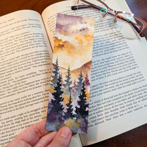 Be greeted by this peaceful autumn sunset watercolor bookmark whenever you open your book! This bookmark is 100% hand painted by me on professional grade watercolor paper and professional paints to ensure your bookmark lasts for years to come! It is double sided and comes with a cute line and dot print on the back! Due to each bookmark being hand painted, please understand that some variation and human error may occur! Print on the back will also vary due to patterns. This bookmark will come wit Autumn Bookmark, Sunset Watercolor, Moody Landscape, Learn Watercolor Painting, Learn Watercolor, Watercolor Books, Watercolor Paintings For Beginners, Purple Sunset, Watercolor Bookmarks