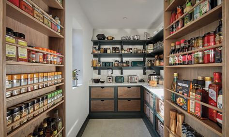 The hidden walk-in pantry is the pièce de resistance in what is already an impressive, one-of-a-kind kitchen. Feeling adventurous and having seen hidden pantries within other Tom Howley projects, it was cleverly integrated into the overall kitchen design, with double doors backed with bespoke racks, opening to reveal breathtaking pantry storage. Discover the design details and tour this inspiring kitchen on our blog. Walk In Larder, Hidden Pantries, Tom Howell, Drinks Area, Dream Kitchen Island, Integrated Wine Cooler, Tom Howley Kitchens, Walk In Pantry Ideas, Tom Howley