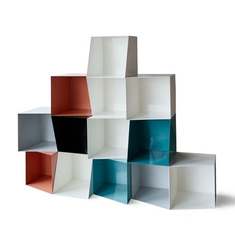 Nicolette de Waart's modular metal sheet bookcase units pulled into symmetry by its angular side, which creates a kaleidoscopic effect of angles for storage Symetrical Shelves, Shelf Asymmetric, Dynamic Shelving, Modular Wall Shelf System, Modular Furniture Design, Modular Shelf, Walnut Bookcase, Contemporary Bookcase, Modern Ottoman