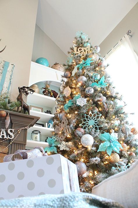 Copper, silver and grays really make the turquoise pop on this snowy Christmas Tree! Turquoise Christmas Tree, Aqua Christmas, Teal Christmas, Turquoise Christmas, Snowy Christmas Tree, Blue Christmas Decor, Blue Christmas Tree, Christmas Tree Ideas, Beautiful Christmas Trees