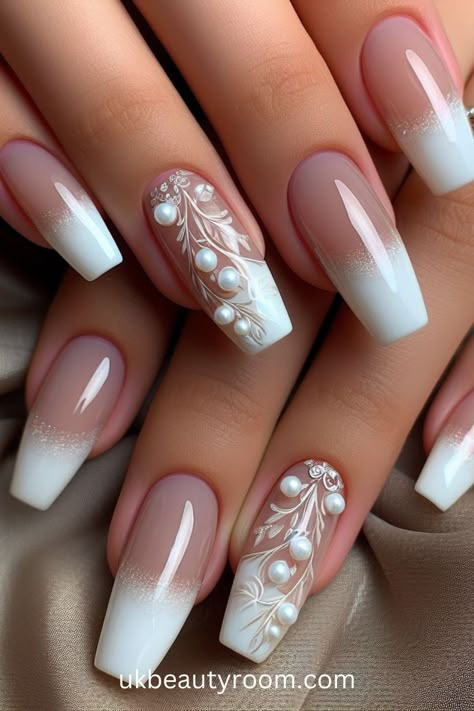 White nails are versatile, timeless, and suitable for any occasion. They offer a clean and polished look that complements any outfit. This post contains 39 white nail designs to help you stand out from the crowd. Cute, milk, milky, brown and, simple, short, gold and, gel, almond, coffin, square, with rhinestones, acrylic, with gems, with charms Wedding Nails Long Square, Nail Design With Pearls Art Ideas, Square White Nails Design, Pretty Nails With Gems, Short Coffin Bridal Nails, Wedding Nails Off White, Ideas For Wedding Nails, Coffin Engagement Nails, Fresh White Nails