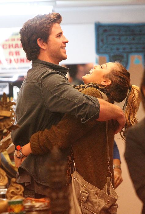 Miley Cyrus and Liam Hemsworth got playful while shopping in Sydney during a June 2011 trip there. Miley Cyrus Wedding, Miley Cyrus Liam Hemsworth, Miley Cyrus And Liam Hemsworth, Miley And Liam, Heartwarming Pictures, Couple Moments, Liam Hemsworth, Famous Couples, Best Moments