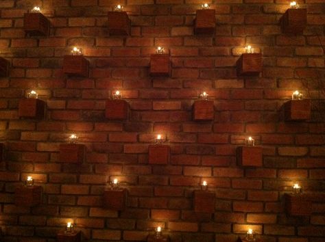 Using bricks as candle holders--actually cementing the candle holders into the wall. Small Garden Patio Ideas, Stone Wall Lighting, Brick Wall Decor Ideas, Mexico Villa, Shrimad Rajchandra, Small Garden Patio, Dancing Studio, Dance Studio Design, Brick Wall Decor