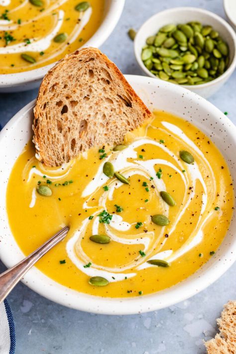 Pumpkin and potato soup served in a bowl with a spoon. Topped with a drizzle of cream and some pumpkin seeds and chopped chives and a slice of crusty bread. Pumpkin Potato Soup, Seafood Breakfast, Vegetarian Seafood, Breakfast Pasta, Instant Pot Pumpkin, Cranberry Walnut Bread, Carrot And Lentil Soup, Squash Vegetable, Creamed Leeks