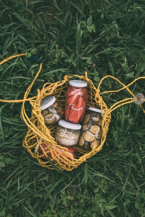 Pickle jar packaging in yellow bag sitting in green grass at a farm the pickle produce was sourced from Farm Produce Photography, Farm Product Photography, Farmers Market Branding, Sustainable Merchandise, Merchandise Photography, Sustainable Photography, Sustainability Photography, Packaging Photoshoot, Farm Packaging