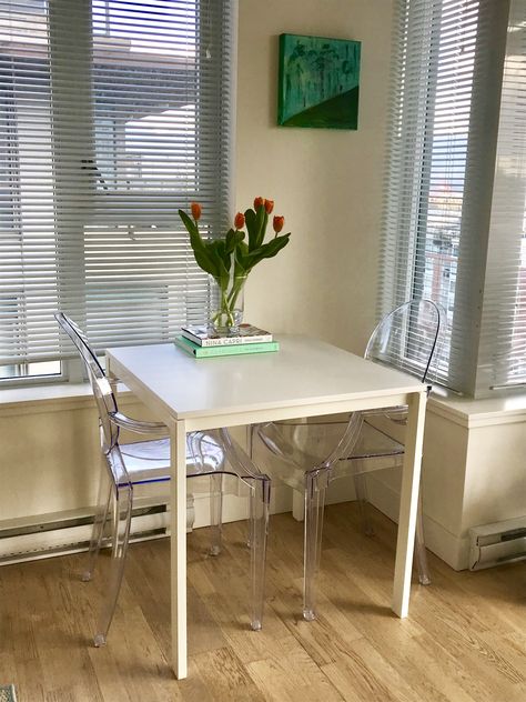 New table and chairs.. great for a small space and the ghost chairs help to brighten the space too #ApartmentDecor #ghostchair #smallspace #clean #ikea #diningroom #diningchair #flowers #coffeetablebooks #cookbook #claridges #ninacapri #tulips #art #melltorp Melltorp Ikea, Ikea Diningroom, Ikea Melltorp Table, Melltorp Table, Ikea Dining Table, Cute Apartment, Ghost Chairs, Tulips Art, Breakfast Table