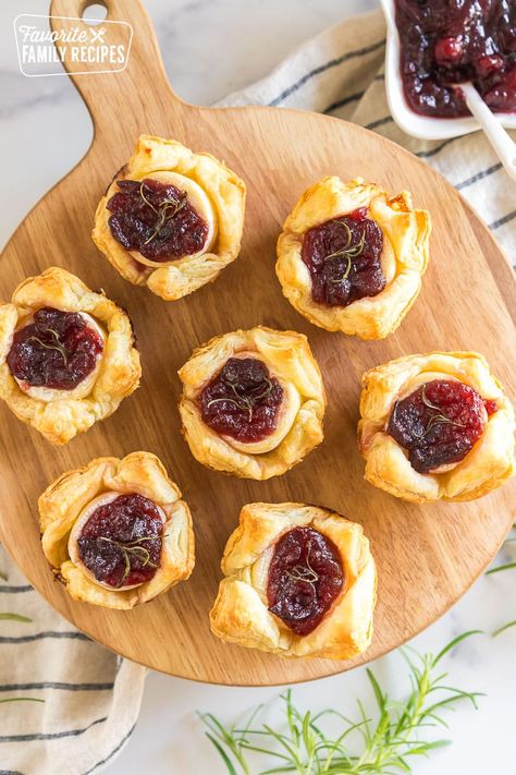 These Cranberry Brie Bites are the perfect holiday appetizer with melty, creamy Brie cheese, tart cranberry sauce, and flaky puff pastry. #cranberrybriebites #holidayappetizers #christmasappetizers #thanksgivingappetizers #briebites Brie Cranberry Appetizer, Brie Bites Puff Pastry, Lite Dinners, Baked Brie Puff Pastry, Cranberry Desserts, Cloves Recipes, Recipes Using Puff Pastry, Cranberry Appetizer, Cranberry Brie Bites