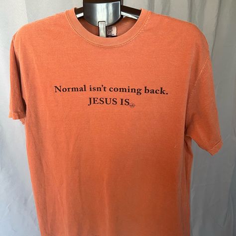 This Vibrant Orange Short Sleeve Tee From Comfort Colors Features A Striking Black Text Graphic On The Front That Reads 'Normal Isn't Coming Back. Jesus Is.' The Shirt Is Made From Soft Cotton-Like Material, Ensuring Comfort For Everyday Wear. Text Graphic, Colors Orange, Orange Shorts, Vibrant Orange, Jesus Is, Comfort Colors, Color Orange, Orange Color, Short Sleeve Tee