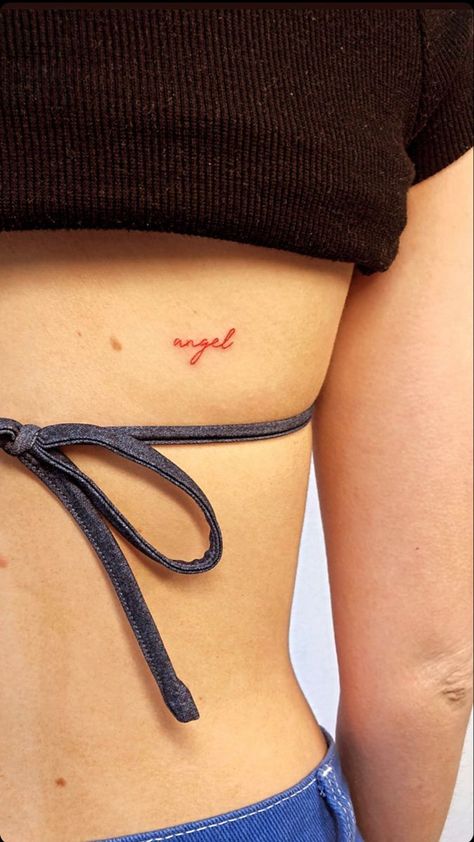 tiny ‘angel’ word tattoo #tattooideas #smalltattoos #tattooideasfemale Angel Tattoo Red Ink, Cursive Red Ink Tattoo, Small Red Tattoo Aesthetic, Angel Tattoo Letters, Angel Red Tattoo, Angel In Cursive Tattoo, Minimalist Red Tattoo Aesthetic, Fine Word Tattoo, Tiny Word Tattoo Placement