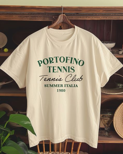 Match point or photoshoot spot? At @thepalms_club, it's always both. 🎾⛰️ Score some style points with our tees and make every game set, match, and snapshot-worthy. #GameSetMatchPhoto . . . . #VintageTee#RetroFashion#PortofinoStyle#TennisClubChic#1980sVintage#ItalianSummer#GraphicTees#EtsyFinds#ShopSmallBusiness#EtsyTShirt#CasualChic#FashionThrowback#SustainableStyle#EtsyShopOwner Tennis Shirts Designs, Tennis T Shirt, Game Set Match, Tennis Whites, Match Point, Anniversary Shirt, Tennis Club, The Palms, Tennis Shirts