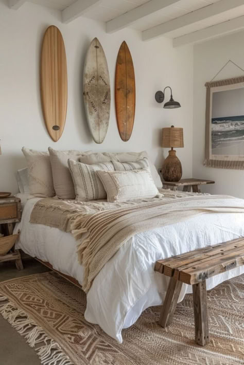 Designed for lovers of the sea and surf, the Bohemian Surfer’s Nook combines practicality with boho style in a charming boho coastal bedroom. Surfboards transform into art pieces, set against a palette of oceanic blues and sandy whites. Durable, comfy furnishings provide a relaxing spot post-surf, enhanced by personal touches like ocean photography. Get tips for styling a surfer’s boho retreat by clicking or tapping here. Beach Modern Bedroom, Dark Bed Ideas, Surfer Apartment, Surfer Girl Aesthetic Bedroom, Surf Bedroom Aesthetic, Boho House Aesthetic, Surfer Bedroom Aesthetic, Boho Surf Bedroom, Ocean Inspired Room