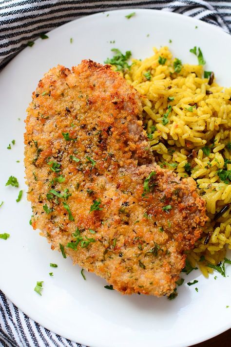 An air fried pork steak on a white plate with seasoned rice next to it. Airfryer Pork Steak, Cube Steak Seasoning, Pork Shoulder Steak Recipes Air Fryer, Pork Cube Steak Recipes Air Fryer, Air Fryer Pork Steaks Bone In, Pork Steaks In Air Fryer, Pork Steak In Air Fryer, Cubed Pork Steak Recipes, Air Fryer Pork Steaks