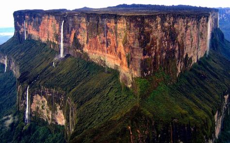 The Guiana Highlands is a very unusual mountain range covering parts of Venezuela, Brazil, Guyana, Suriname and French Guiana. The highlands are made of ancient sedimentary rock that is over two billion years old and are some of the oldest sedimentary rocks on the planet.  The mountain is known as a Tepui, which describes a flat-topped mountain with vertical sides. Many waterfalls spill off Roraima, and the other Tepuis Monte Roraima, Mount Roraima, Socotra, The Lost World, Breathtaking Places, Sanya, Bagan, Fallen Angel, Places Around The World