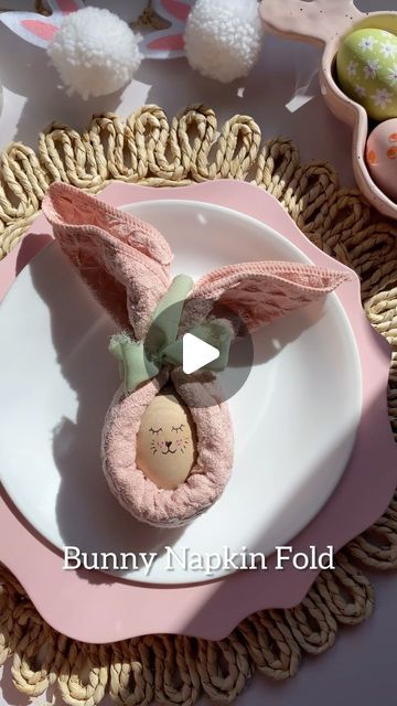 Amanda on Instagram: "Bunny napkin fold 🐰

This is an easy way to make your Easter tablescape a little more festive. You just need a cloth napkin/hand towel and ribbon to create the bunny ears. 

Simply fold the napkin half, then tuck a corner in and fold until you have no more left (a square napkin works best for this!)

I used a wood egg, fine sharpie and pink colored pencil to create the bunny face.

#diydecor #tablescape #eastertable #homedecor #easterdecor #easterdiy #diyhomedecor #cozyhome #easterparty #springdecor #easterbunny #diningtable #placesetting #momhacks #craftymom #diymom #eastereggs #eggdecorating #easteregg" Bunny Napkin Fold, Oster Brunch, Diy Bunny, How To Make Eggs, Bunny Napkins, Wood Eggs, Easter Tablescapes, Ring Holders, Napkin Folding