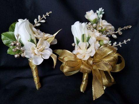 Perfect corsage for 50th Golden Wedding Anniversary!  This silk corsage and boutonniere is sparkly and eye-catching.  The pin-on corsage has a cream rose, small golden flowers, gold glittery leaves and balls.  The corsage has gold ribbon.    The boutonniere is approximately 5 inches long, includes the gold glittery leaves and balls, and the stem is wrapped in gold ribbon.    https://www.etsy.com/shop/PetalsAndRibbon?ref=profile_shopname Gold And White Corsage, Gold Wedding Brooches In Flower Shape, Gold Corsage Prom, Silk Corsage, Elegant Gold Flower Lapel Pin, Ivory Corsage, White Flower Gold Ribbon Corsage, Elegant Gold Flower Brooches, Gold Corsage