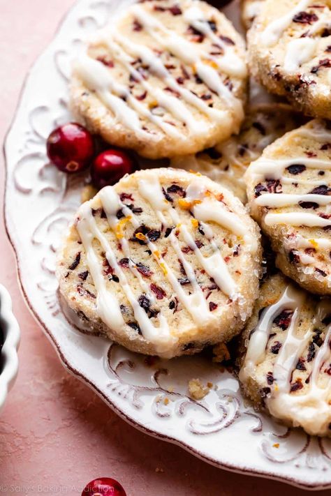 These slice-and-bake style cranberry orange icebox cookies deliver big flavor from surprisingly simple ingredients. They're filled with chewy dried cranberries and fragrant orange zest. Drizzle on an easy 2-ingredient orange glaze for the finishing touch. Recipe on sallysbakingaddiction.com Cranberry Orange Shortbread Cookies, Cranberry Orange Cookies, Icebox Cookies, Easy Christmas Cookie Recipes, Orange Cookies, Sally's Baking, Orange Glaze, Christmas Cookies Easy, Best Christmas Cookies