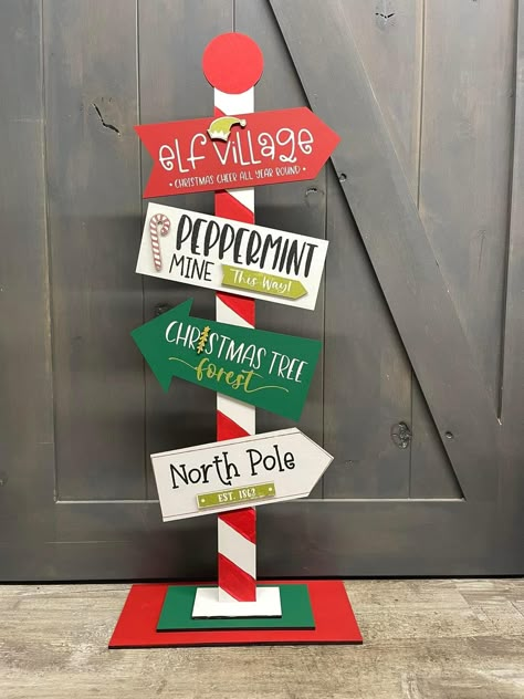 Santas Village Display, Stand Up Porch Signs, Wood Cutout Christmas Decor, Christmas Directional Signs, Christmas Decor Ideas For Work, Outdoor Christmas Signs, The Grinch Christmas Decorations Diy, Dollar Store Christmas Crafts Diy, Diy Indoor Christmas Decorations