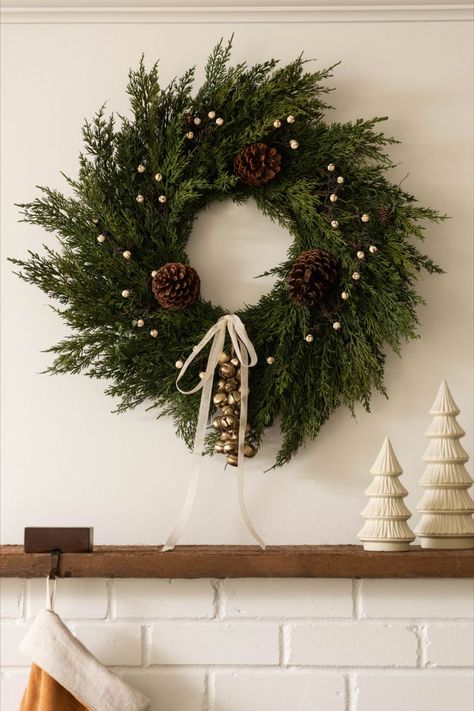 Whether yours finds a home on the front door, above a mantel, or in the kitchen, wreaths add a hint of magic and nostalgia anywhere they're placed. We’ve pulled together four simple ideas to spruce up your holiday wreath this season. Wreaths On Fireplace, Scandi Wreath Christmas, Minimal Wreath Christmas, Wreath Inspo Christmas, Christmas Wreath Fireplace, Indoor Christmas Wreaths, Simple Christmas Wreaths For Front Door, Minimal Christmas Wreath, Christmas Wreath Ideas 2023