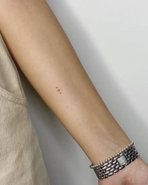 Minimalist Tattoo Arms Women, Words Tattoo Minimalist, Mini Tattoos Arm, Joy Tattoo Ideas, Joy Tattoo, Tiny Tats, Simple Arm Tattoos, Small Pretty Tattoos, Writing Tattoos