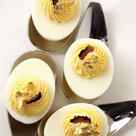 Everyone needs one quick, easy, go-to recipe that looks and tastes like a million bucks. These eggs work like a charm: the fragrant truffle oil adds rich, sexy appeal, and a sprinkle of black lava salt lends an elegant finish. Make them super bling by adding a tiny flake of edible 24k gold leaf to each. Truffle Deviled Eggs, Truffle Oil Recipes, Thanksgiving Deviled Eggs, Recipe Appetizers, Devilled Eggs Recipe Best, Avocado Deviled Eggs, Best Deviled Eggs, Bacon Deviled Eggs, Deviled Eggs Classic