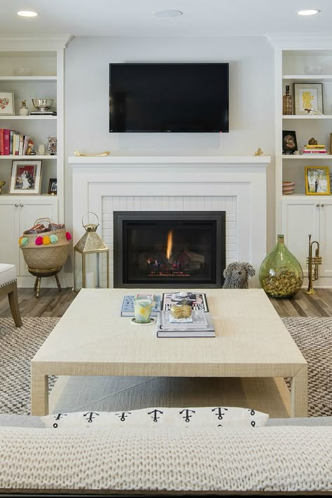 Thoughtful pops of color and layers of nubby textures lend this living room a comfortable, lived-in feel. Installing our Escape Gas FireBrick Insert allowed for a seamless, clean-looking hearth surrounded by a white-on-white brick and mantle combination. And with Direct Vent technology, putting a TV above the fireplace is 100-percent safe. Photo c/o @stonewoodllc. Tv Above Fireplace, Painted Brick Fireplaces, Gas Fireplace Insert, Fireplace Built Ins, Fireplace Insert, Fireplace Remodel, Gas Fire, Home Fireplace, Fireplace Makeover