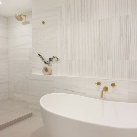 Renovating your home is easier than ever with Bianco Dolomiti Classic Honed Marble Tile. From bathrooms to kitchens, you can make any location look perfect. Marble is a material that has been used by the rich and powerful for centuries. The ancients, like Egypt's Pharaohs had marble in their tombs to show off how much they could afford. If you're looking for exclusivity then Marble Tiles might be just what your home needs. Marble offers many decorating options, which can help you achieve that lu Limestone Bathroom Floor Master Bath, Fluted Marble Tile Bathroom, Tub With Tile Walls Master Bath, White Marble Tile Bathroom Ideas, Primary Bathroom Shower Tile, Porcelain Marble Tile Bathroom, White Master Bath Ideas, Marble Floor Bathroom, White Marble Bathroom