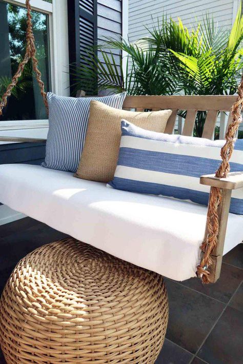 Coastal front porch makeover with driftwood gray swing, with the chain wrapped in rope. Sun washed blues, sandy textures, and palms that wave in the breeze give you that sand in your toes feeling. Coastal living right in town. #coastaldecor #coastalchic #frontporch #porchideas #patioideas Florida Front Porch Ideas, Coastal Porch Ideas, Coastal Front Porch, Sunroom Layout, Coastal Porch, Farmhouse Porch Swings, Porch Refresh, Beach Porch, Coastal Patio